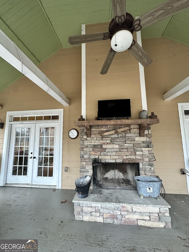 exterior space with french doors and a stone fireplace