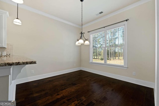 unfurnished dining area featuring dark hardwood / wood-style floors and ornamental molding