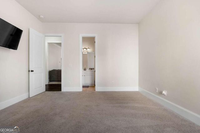 unfurnished bedroom with carpet floors and ensuite bath