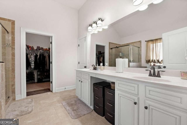 bathroom featuring tile patterned floors, vanity, an enclosed shower, and lofted ceiling