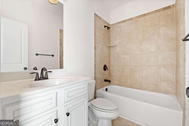 full bathroom featuring toilet, vanity, and tiled shower / bath