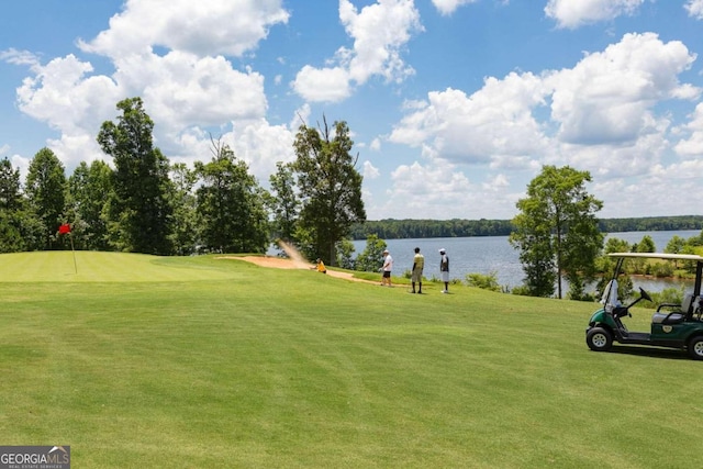 view of community featuring a yard and a water view