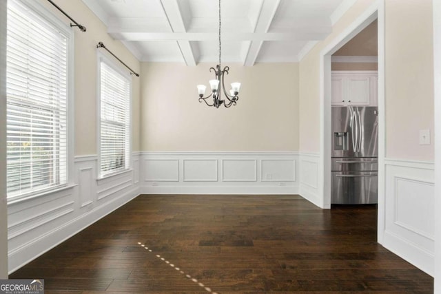 unfurnished dining area with beamed ceiling, dark hardwood / wood-style floors, a healthy amount of sunlight, and coffered ceiling