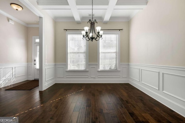 unfurnished dining area with beam ceiling, crown molding, dark wood-type flooring, and a notable chandelier