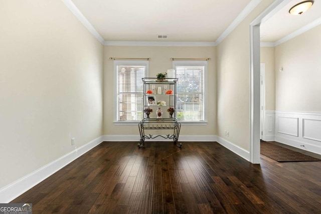 interior space featuring dark hardwood / wood-style floors and ornamental molding