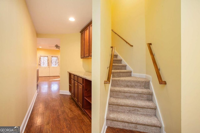 staircase with hardwood / wood-style flooring