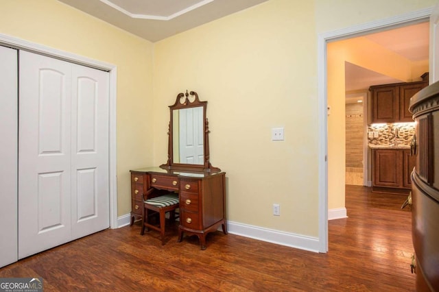 interior space with dark hardwood / wood-style flooring, refrigerator, and a closet