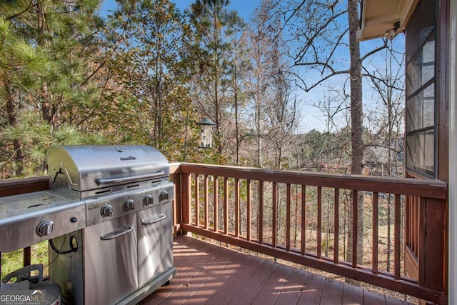 wooden terrace featuring grilling area