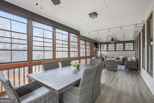 sunroom with rail lighting and ceiling fan