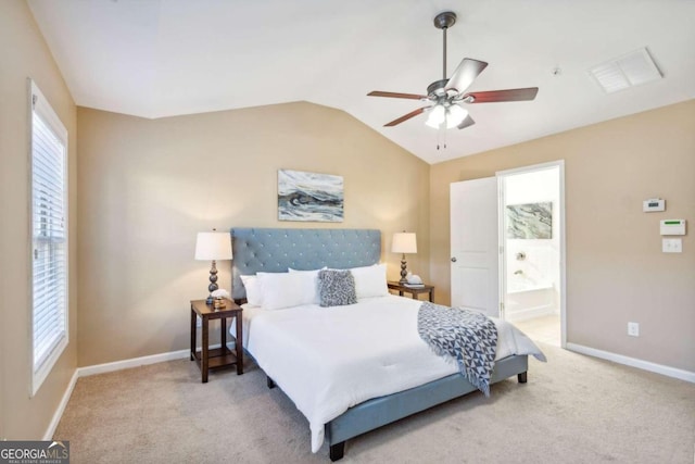 bedroom with carpet floors, multiple windows, ensuite bathroom, and ceiling fan