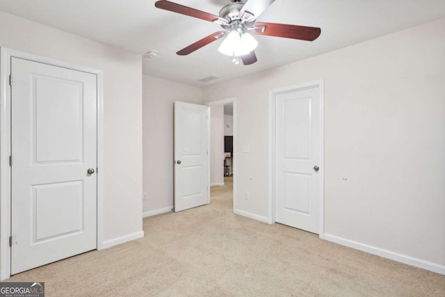 unfurnished bedroom with ceiling fan and light carpet