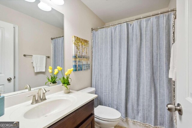 bathroom featuring vanity and toilet