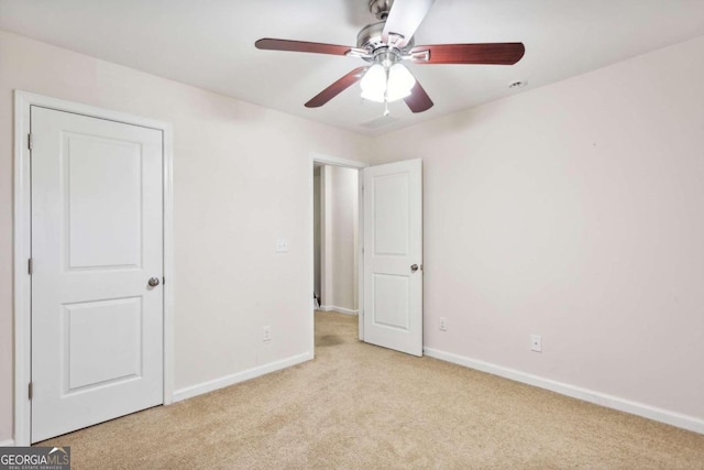 unfurnished bedroom with ceiling fan and light carpet