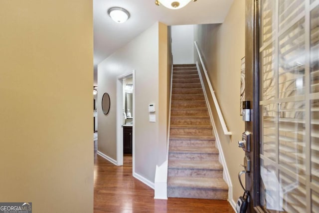 staircase with wood-type flooring