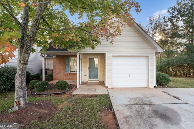 view of front of house featuring a porch, concrete driveway, brick siding, and an attached garage