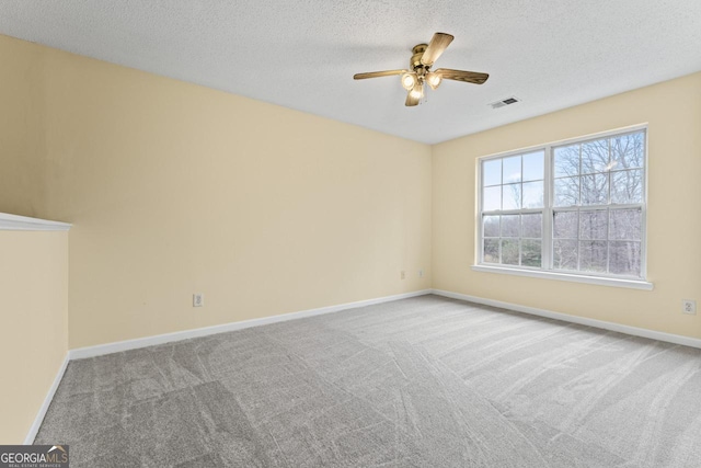 unfurnished room featuring baseboards, a textured ceiling, visible vents, and carpet flooring