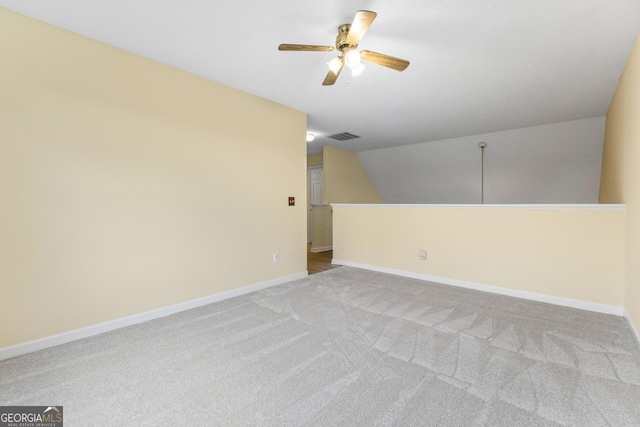 spare room featuring a ceiling fan, carpet flooring, visible vents, and baseboards