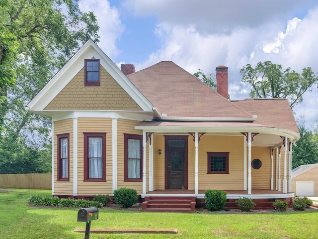 view of front of home with a porch and a front lawn