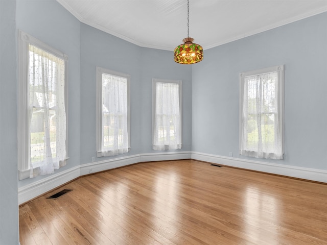 empty room with light wood-type flooring and ornamental molding