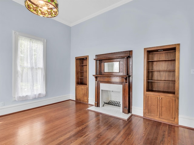 unfurnished living room with crown molding and wood-type flooring