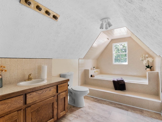 bathroom with a bathtub, vanity, lofted ceiling, toilet, and a textured ceiling