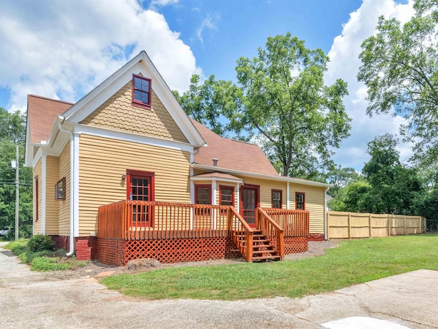 back of property featuring a yard and a deck