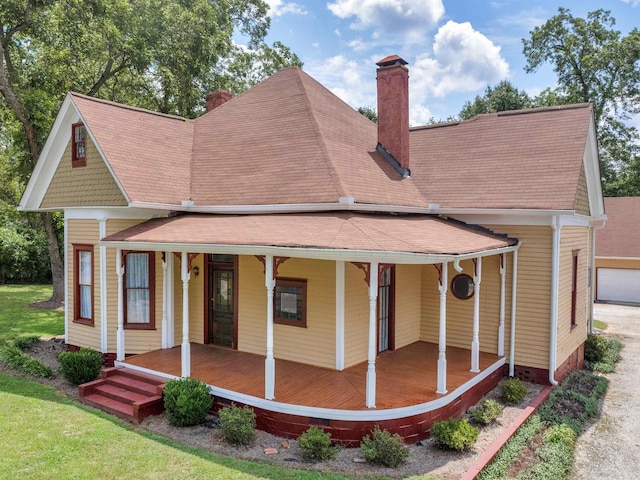 back of property featuring covered porch