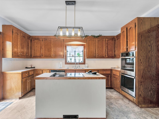 kitchen featuring stainless steel appliances, a kitchen island, hanging light fixtures, and ornamental molding