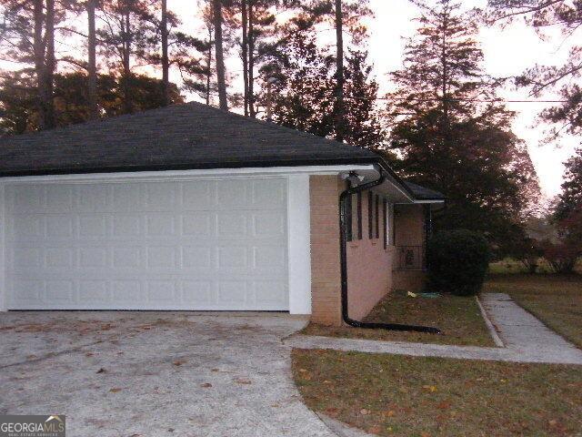 property exterior at dusk with a garage