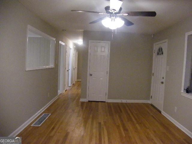 unfurnished room with hardwood / wood-style flooring and ceiling fan