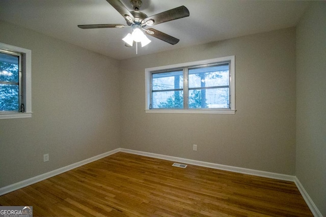 spare room featuring wood-type flooring and ceiling fan