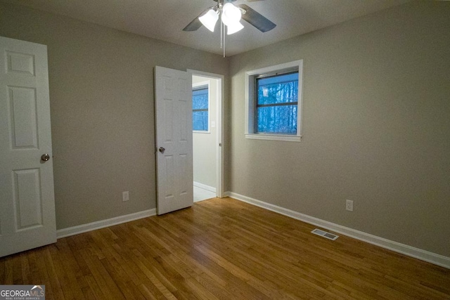 unfurnished bedroom with hardwood / wood-style floors and ceiling fan