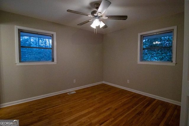 unfurnished room featuring dark hardwood / wood-style floors and ceiling fan