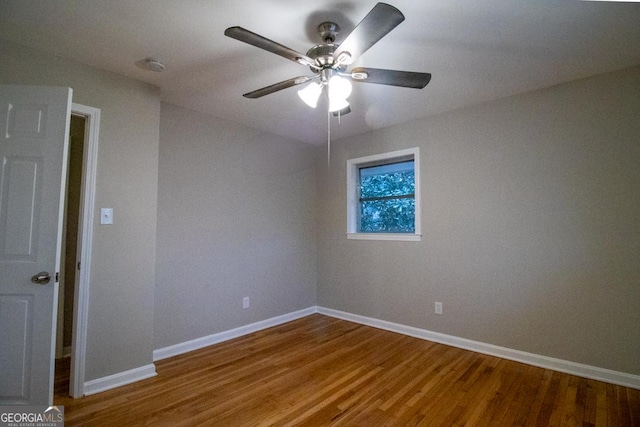 empty room featuring hardwood / wood-style flooring and ceiling fan