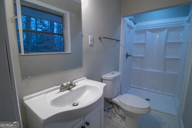 bathroom with vanity, toilet, and walk in shower