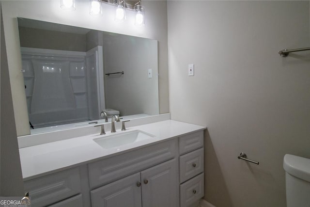 bathroom featuring vanity and toilet