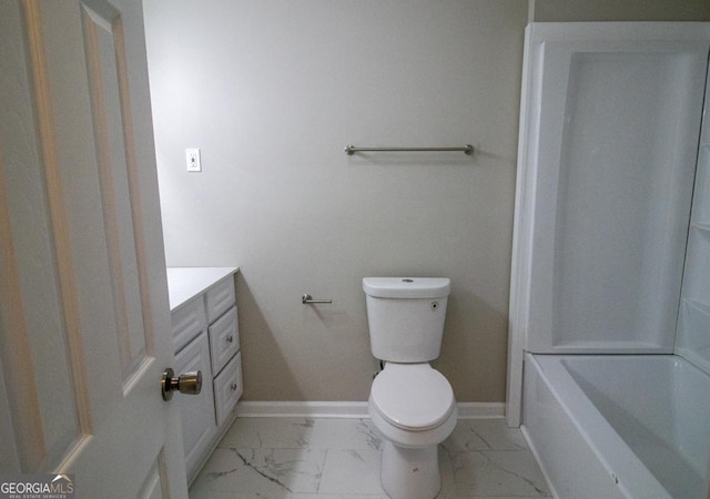 bathroom featuring vanity, a bath, and toilet