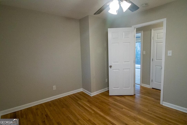 empty room featuring ceiling fan and light hardwood / wood-style flooring