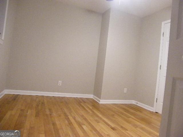 unfurnished room with light wood-type flooring