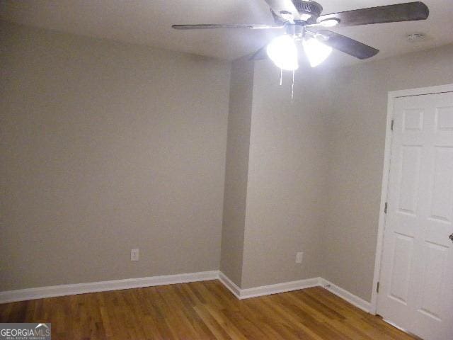 unfurnished room with ceiling fan and wood-type flooring