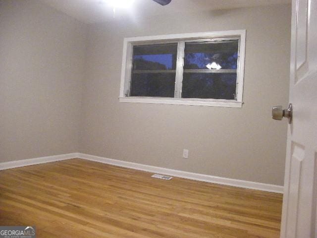 spare room featuring hardwood / wood-style flooring