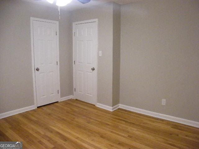 spare room with ceiling fan and hardwood / wood-style floors