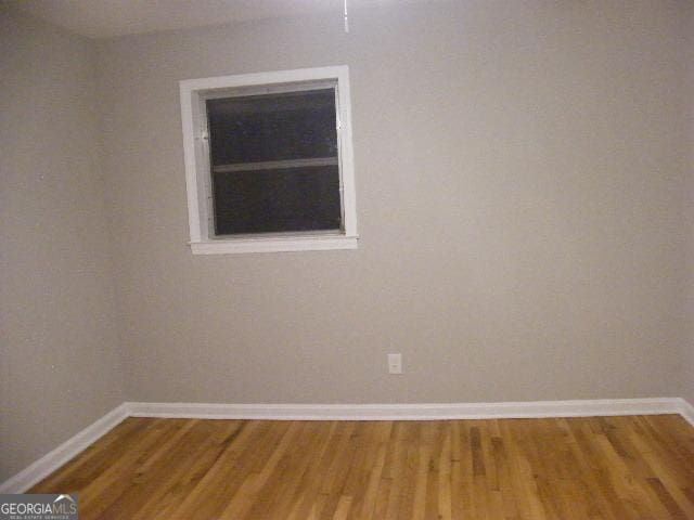 spare room featuring hardwood / wood-style flooring