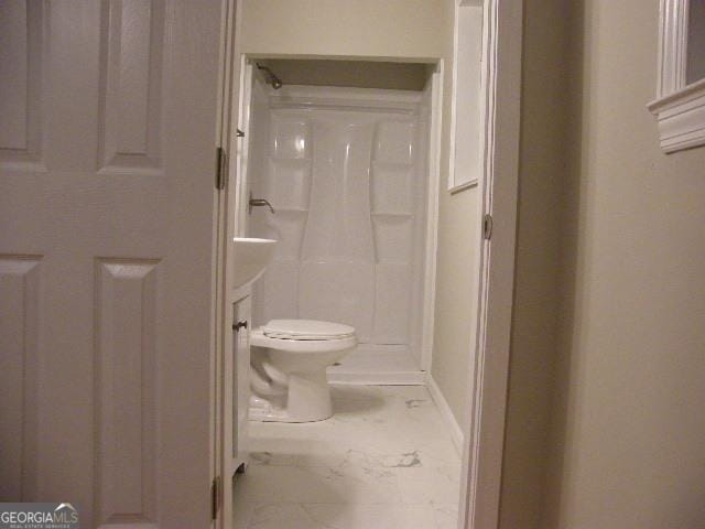 bathroom featuring toilet and a shower