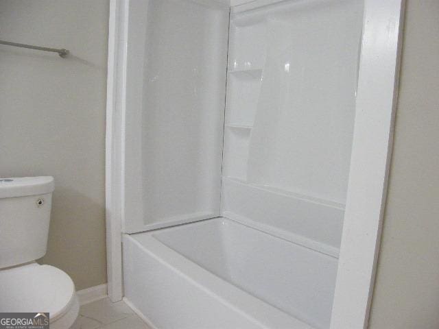 bathroom with toilet and tile patterned flooring