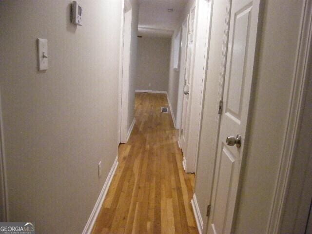 hall with light hardwood / wood-style flooring