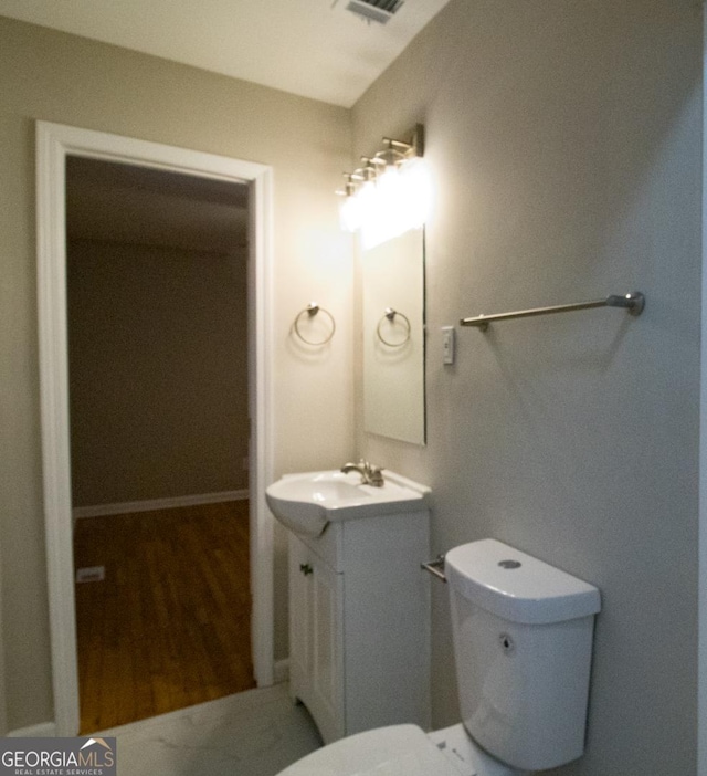 bathroom with vanity and toilet