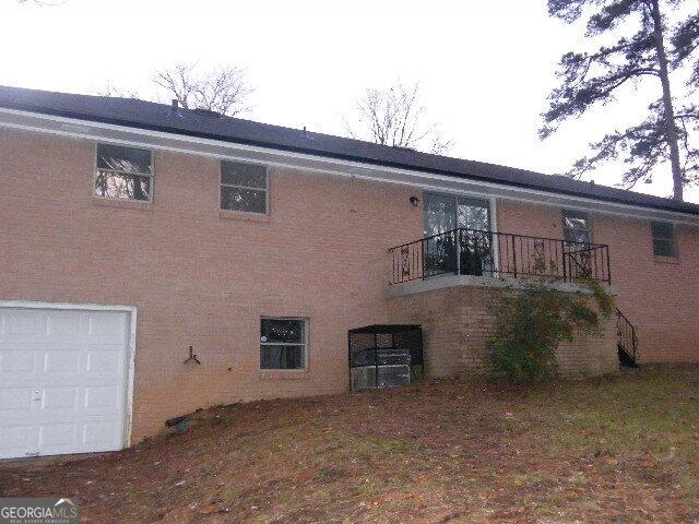 back of property with a balcony