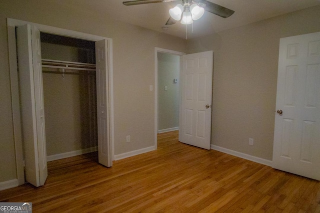 unfurnished bedroom featuring light wood-type flooring, ceiling fan, and a closet