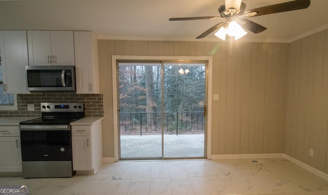 kitchen with white cabinetry, crown molding, ceiling fan, and appliances with stainless steel finishes